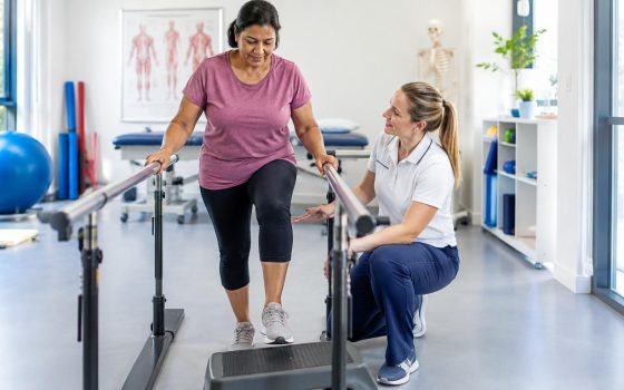 British adult completing weight bearing exercises with a physiotherapist